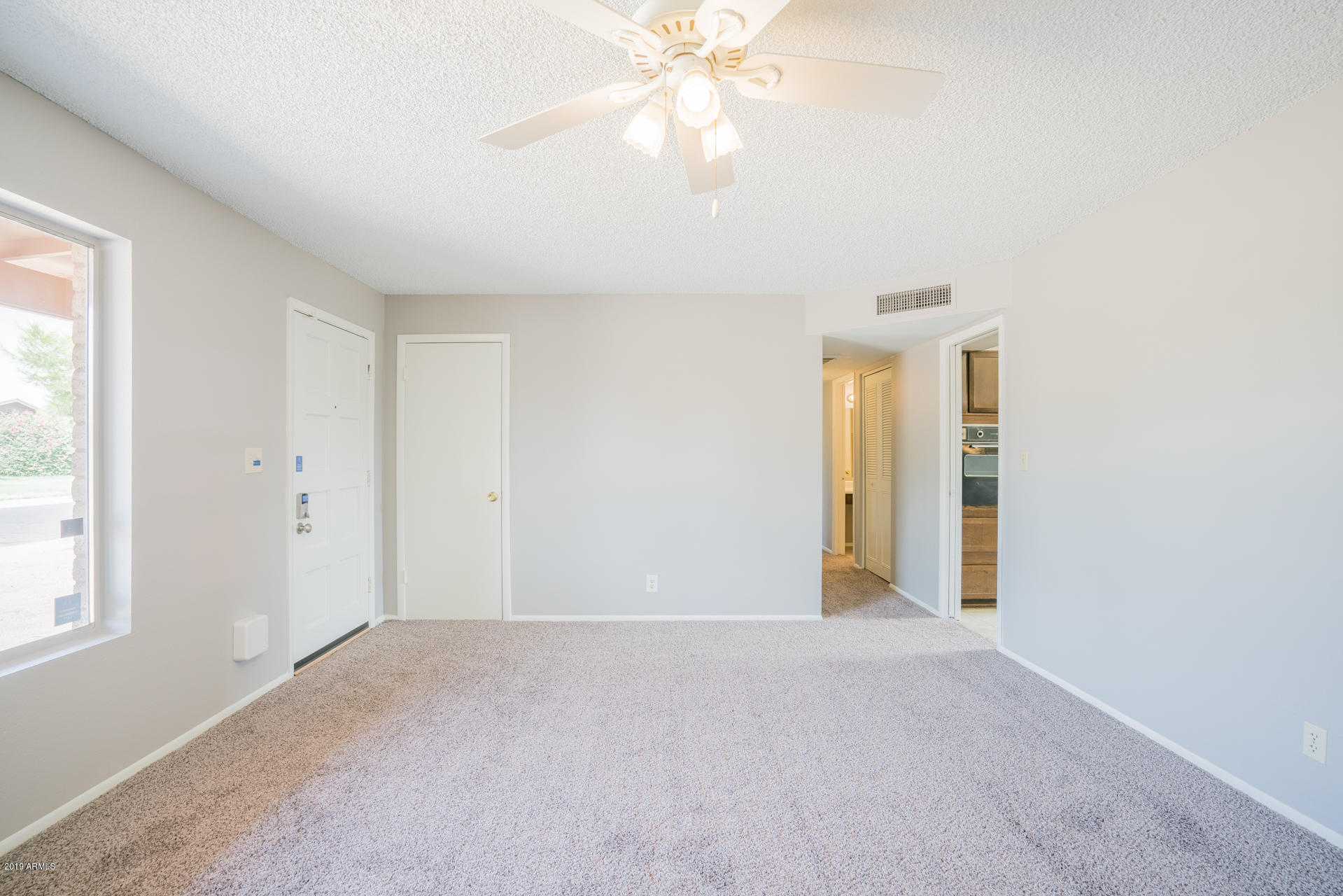 3845 West Hatcher Road Phoenix, AZ 85051 - Photo 2 of 19 a view of an empty room with a window