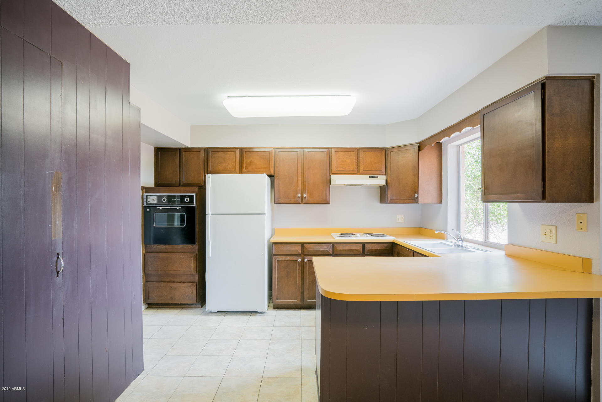 3845 West Hatcher Road Phoenix, AZ 85051 - Photo 3 of 19 a kitchen with a stove a refrigerator and a sink