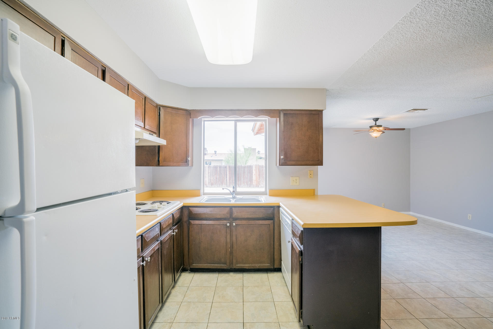 3845 West Hatcher Road Phoenix, AZ 85051 - Photo 4 of 19 a kitchen with a sink a stove and refrigerator