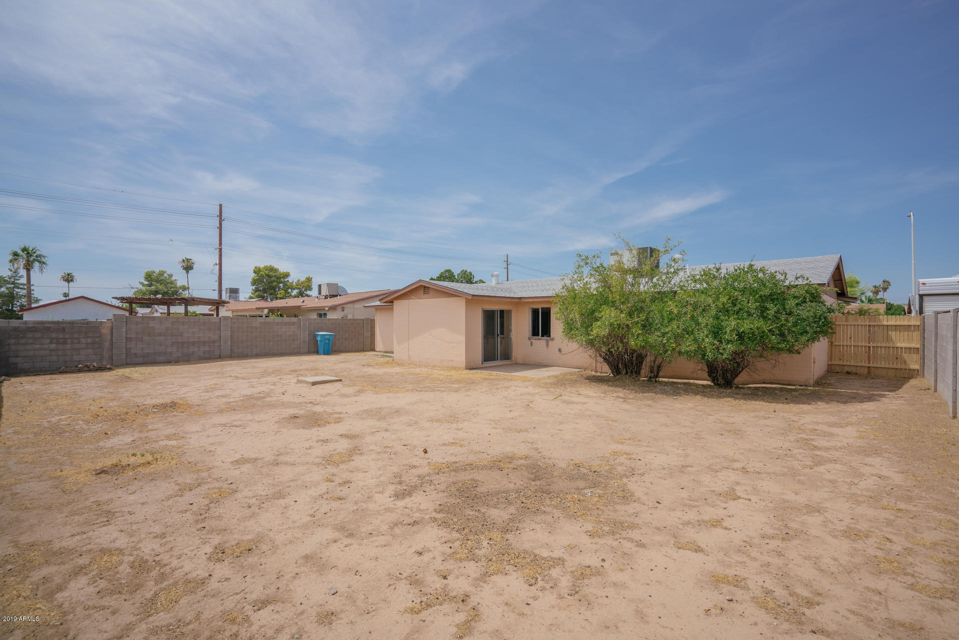 3845 West Hatcher Road Phoenix, AZ 85051 - Photo 5 of 19 a big room with potted plants and a large window