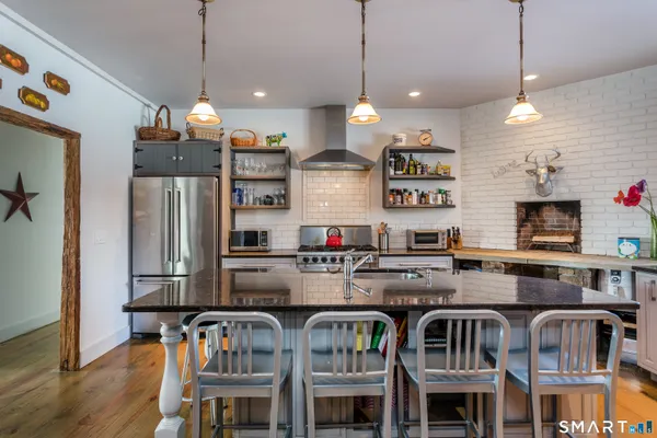 a kitchen with stainless steel appliances granite countertop a stove and refrigerator