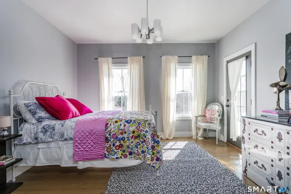 a bedroom with bed and windows