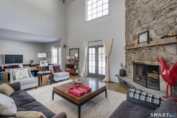 a living room with furniture a fireplace and a flat screen tv
