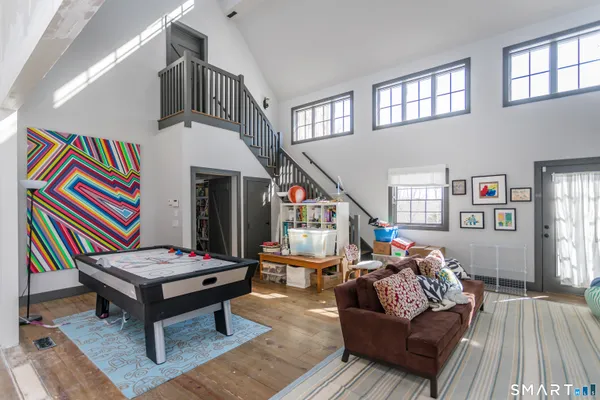 a living room with furniture and a wooden floor