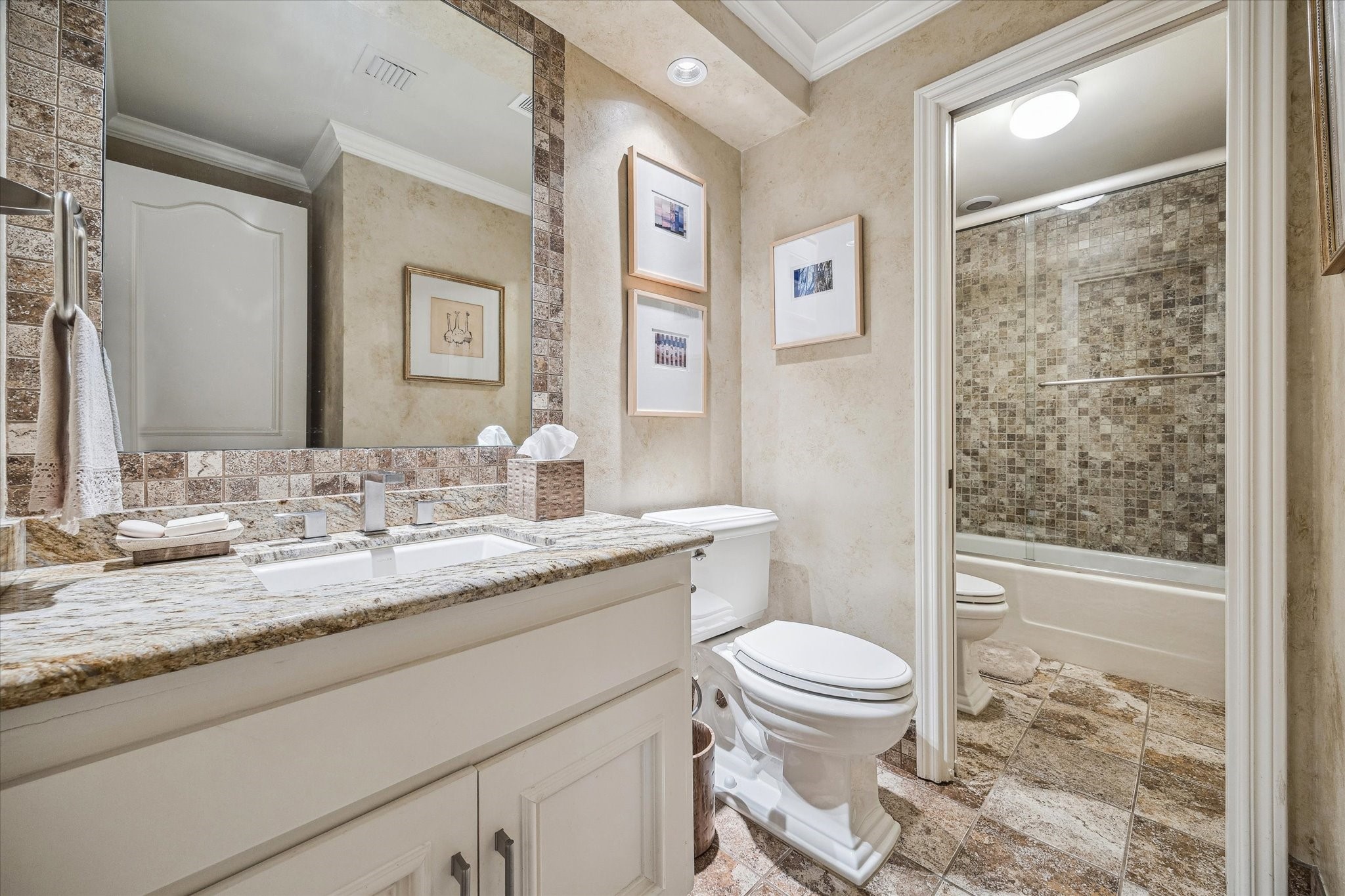 101 Westcott Street, Unit 202 Houston, TX 77007 - Photo 22 of 33 a bathroom with a granite countertop sink a toilet and shower