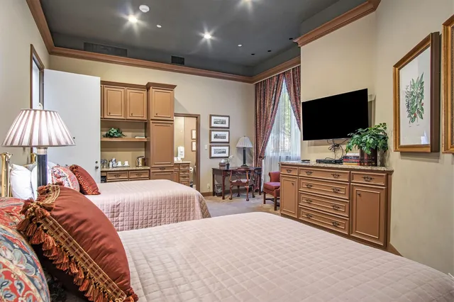 a bedroom with furniture and a flat screen tv