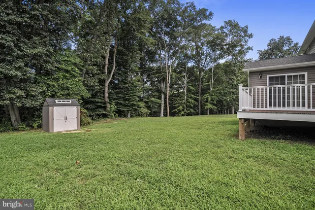 a backyard of a house with barbeque oven and fence