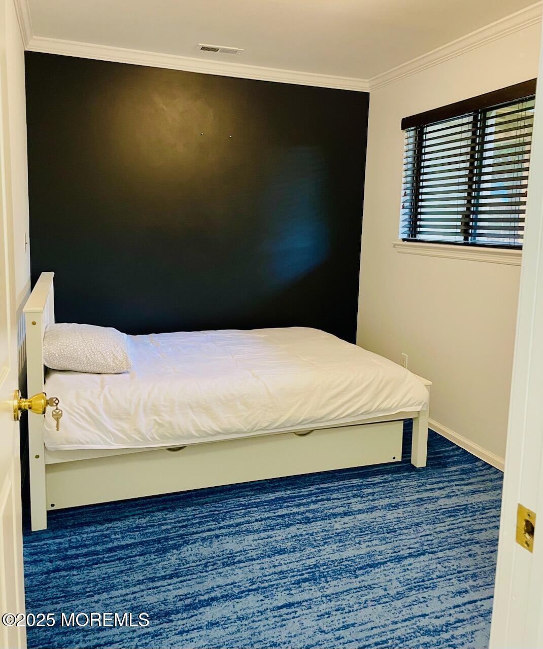 190 Spruce Street, Unit 8 Long Branch, NJ 07740 - Photo 12 of 15 a bed sitting in a bedroom next to a window