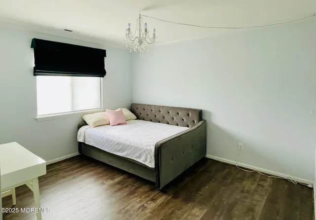 a bed sitting in a bedroom next to a window