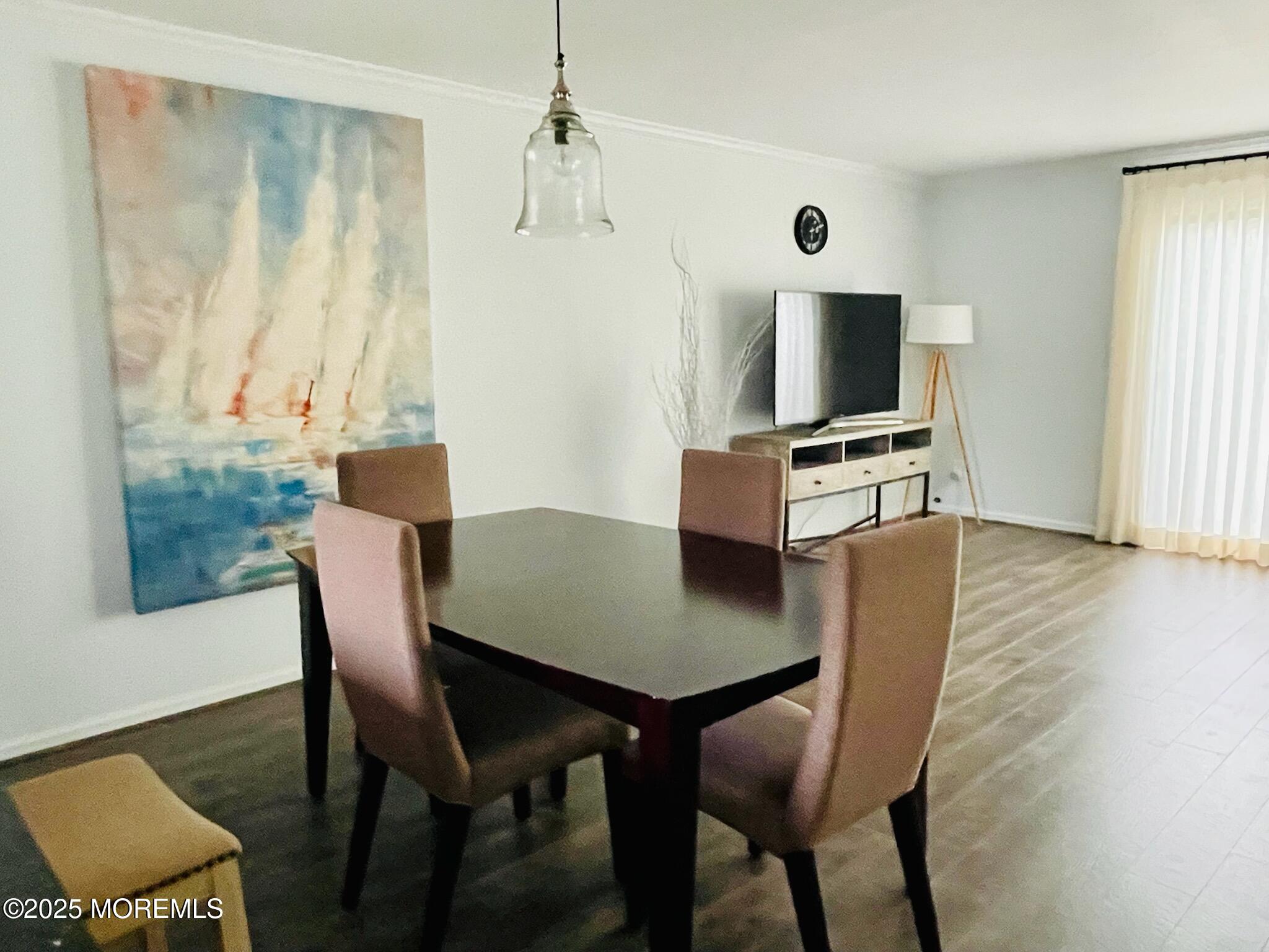 190 Spruce Street, Unit 8 Long Branch, NJ 07740 - Photo 6 of 15 a view of a dining room with furniture and wooden floor