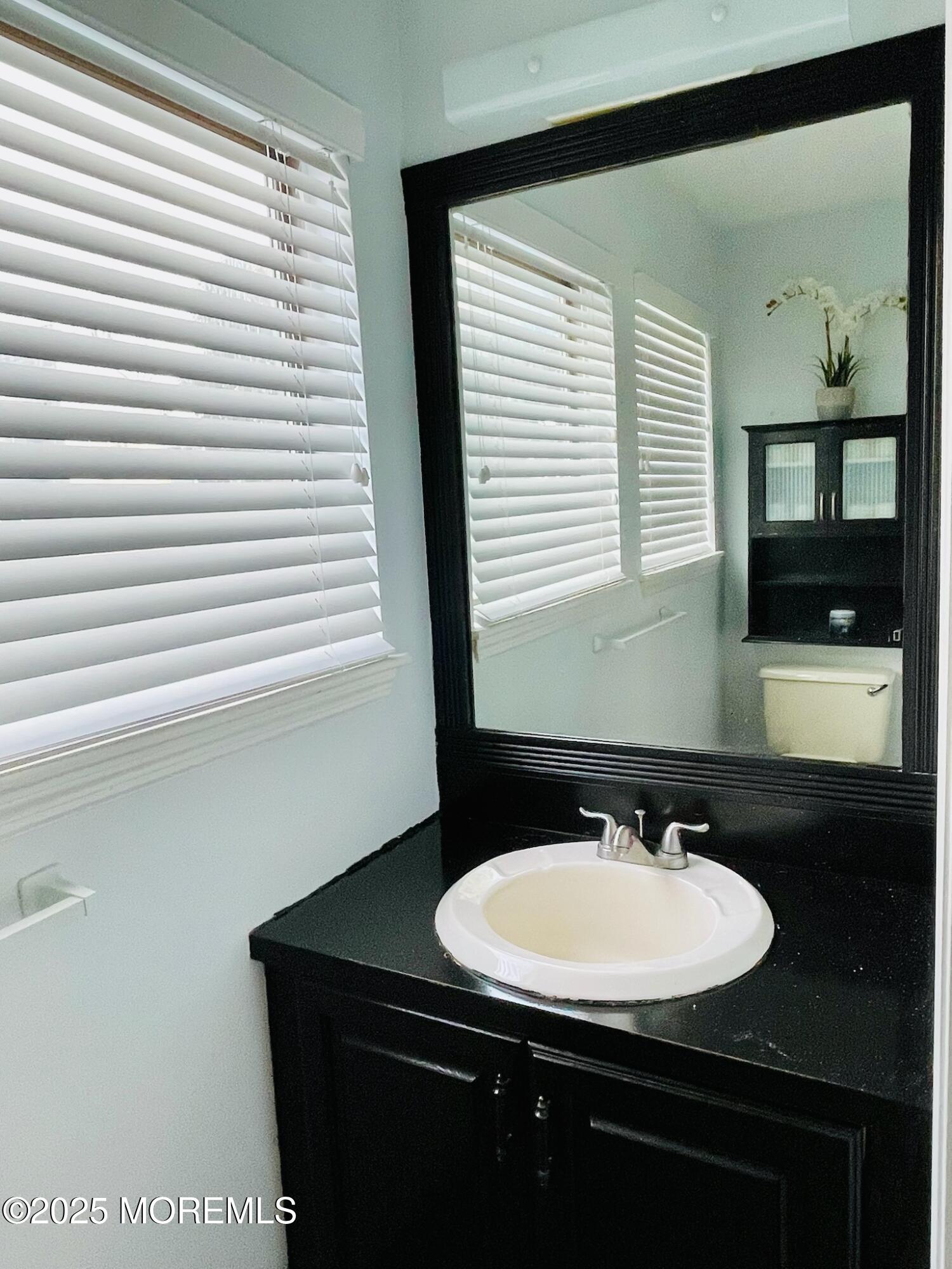 190 Spruce Street, Unit 8 Long Branch, NJ 07740 - Photo 10 of 15 a bathroom with a sink and a mirror