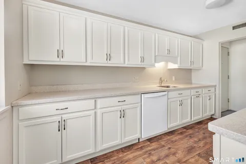 a kitchen with a sink stove and refrigerator