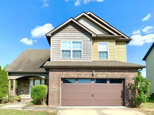 a front view of a house with garage