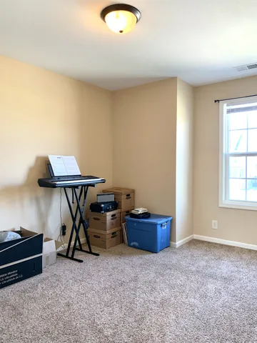 an empty room with furniture and windows