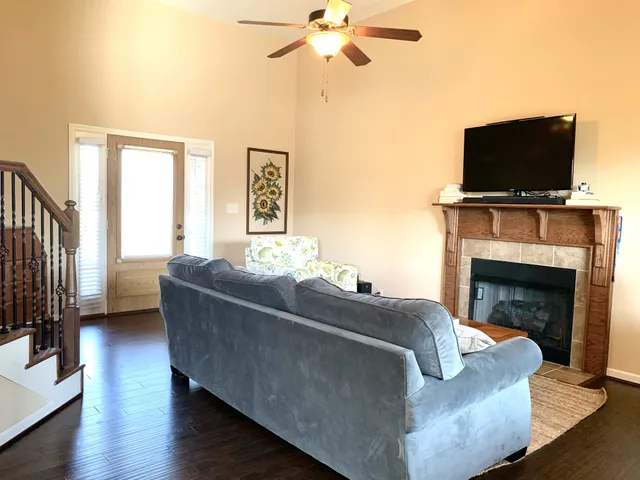 a living room with furniture fireplace and flat screen tv