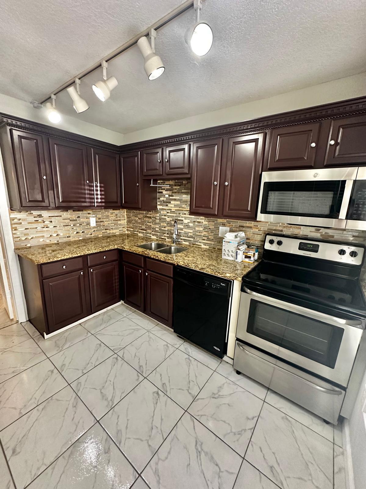 a kitchen with stainless steel appliances granite countertop a stove and a sink