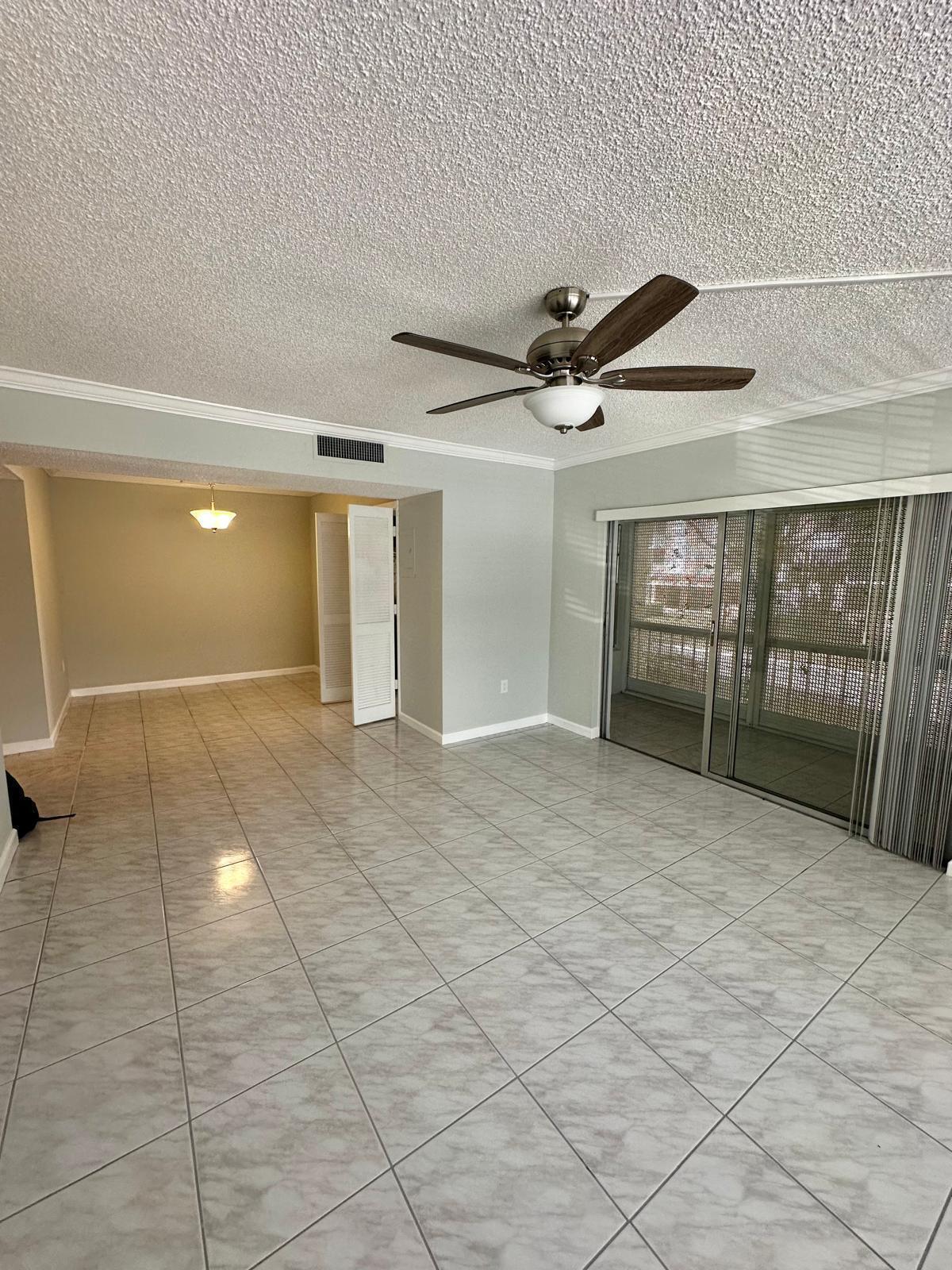 4158 Inverrary Drive, Unit 202 Lauderhill, FL 33319 - Photo 14 of 20 a view of a livingroom with a ceiling fan and window