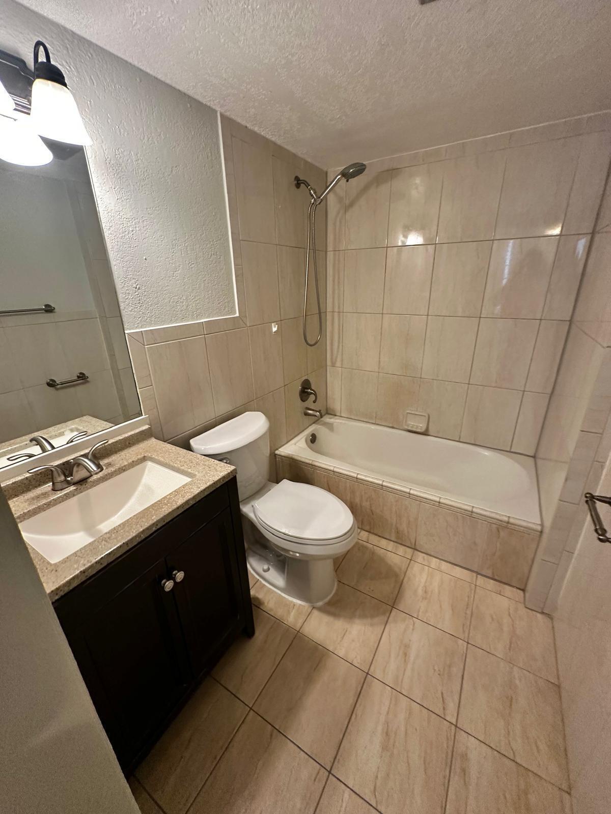 4158 Inverrary Drive, Unit 202 Lauderhill, FL 33319 - Photo 2 of 20 a bathroom with a sink toilet and shower