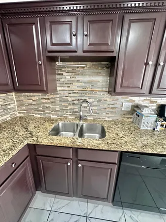 a kitchen with granite countertop stainless steel appliances and cabinets