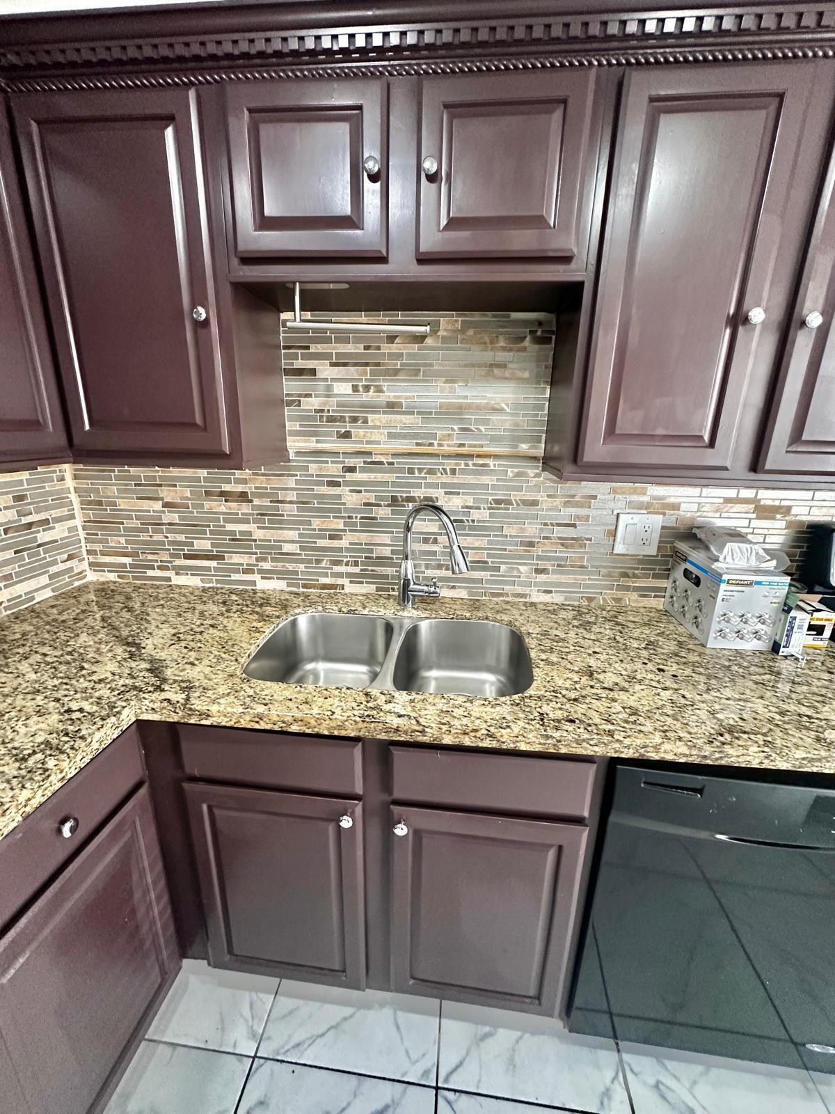 4158 Inverrary Drive, Unit 202 Lauderhill, FL 33319 - Photo 4 of 20 a kitchen with granite countertop stainless steel appliances and cabinets