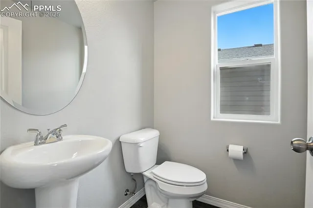 a bathroom with a sink toilet and a mirror