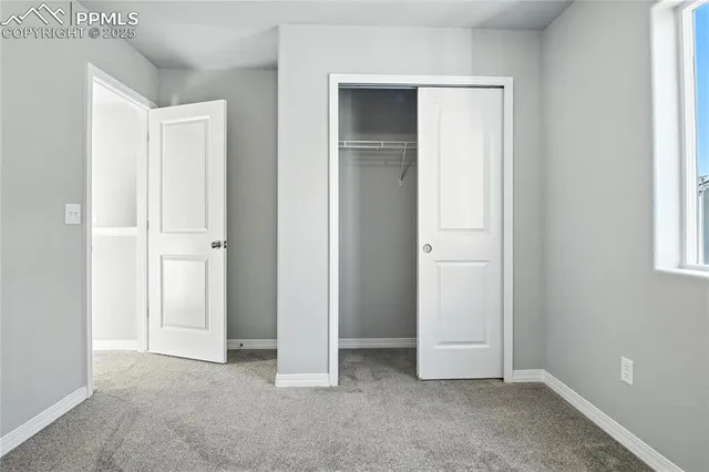 an empty room with windows and closet
