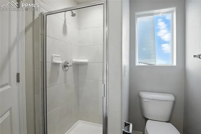 a bathroom with a toilet and shower