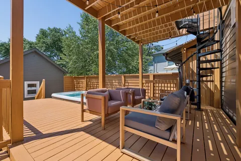 a view of a house with backyard and deck