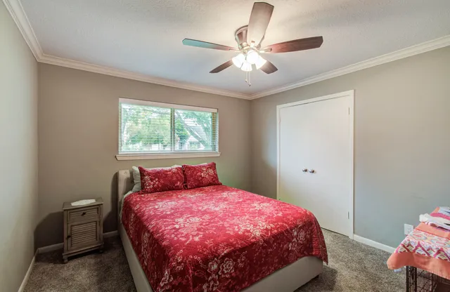 a bed sitting in a bedroom next to a window
