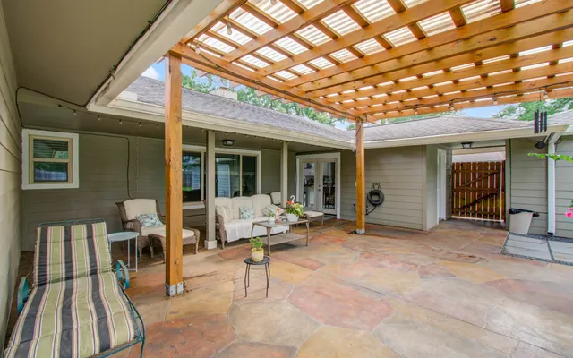 a backyard of a house with barbeque oven table and chairs