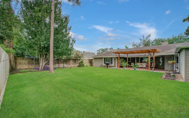 a view of an house with backyard outdoor seating and hardwood