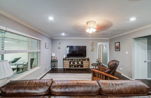 a living room with furniture and a flat screen tv