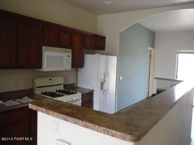 4605 North Miller Road Rimrock, AZ 86335 - Photo 6 of 20 a kitchen with a refrigerator and a stove top oven