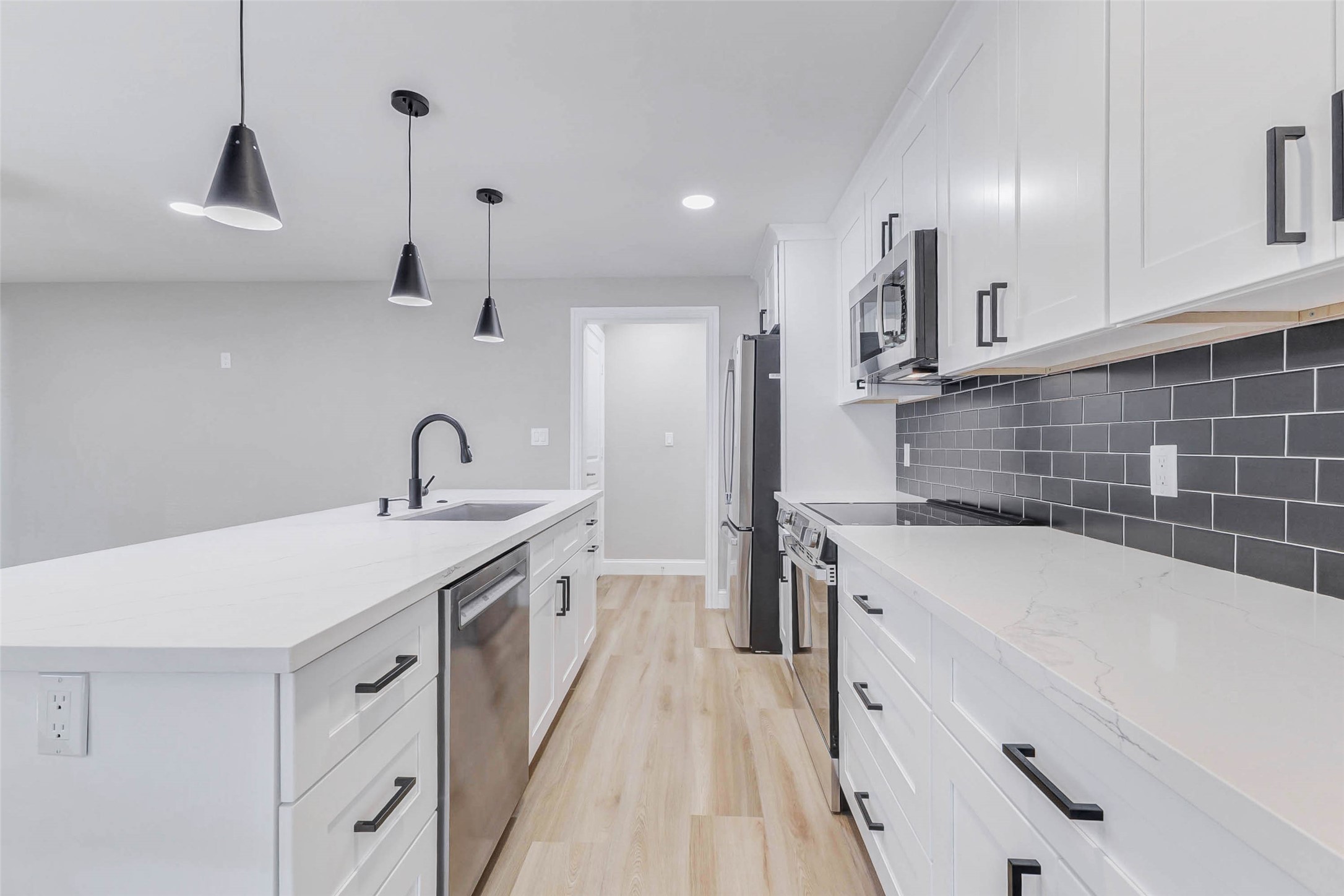 1054 Dewalt Street Houston, TX 77088 - Photo 17 of 24 a kitchen with a sink a stove and cabinets