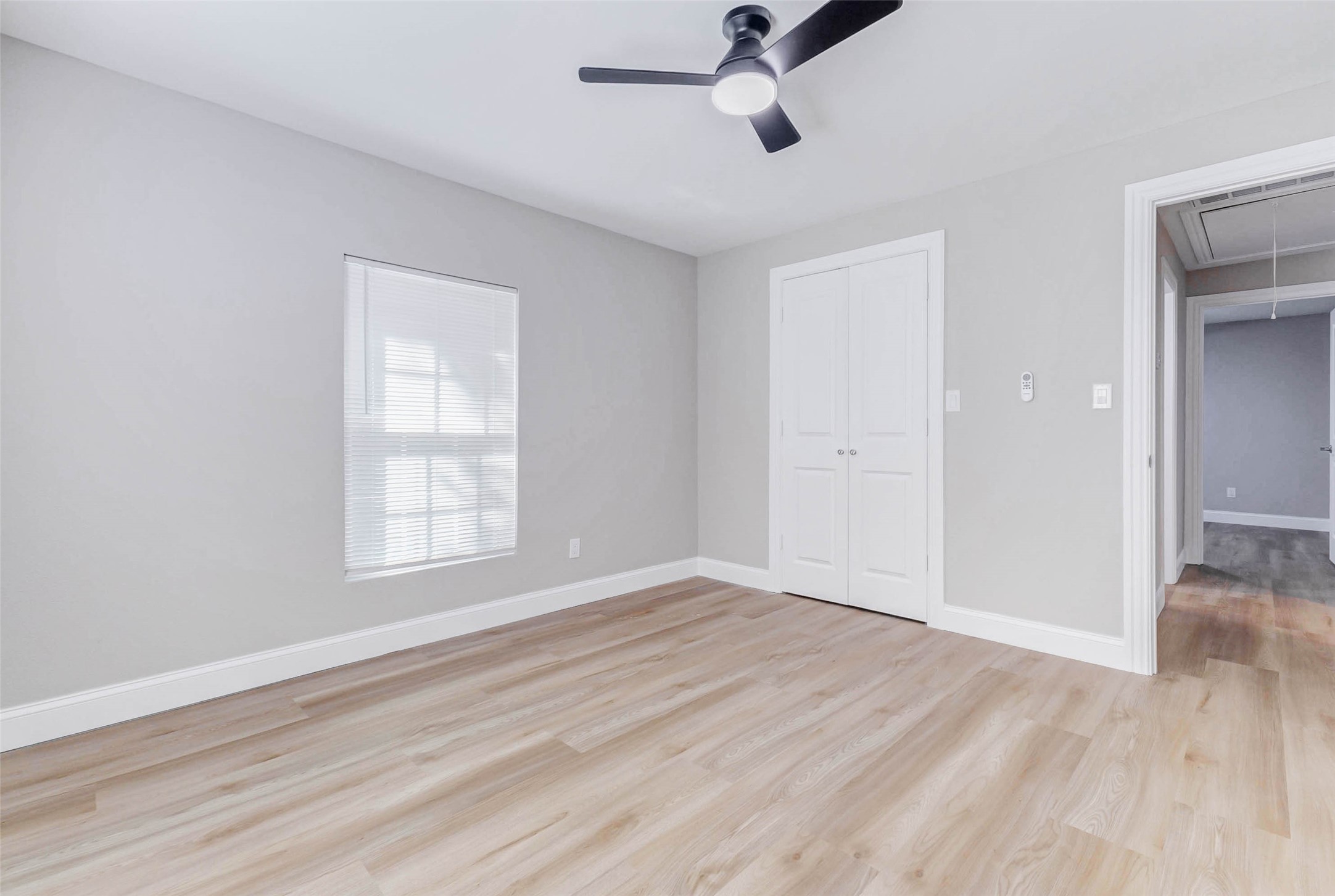 1054 Dewalt Street Houston, TX 77088 - Photo 18 of 24 an empty room with wooden floor cabinet and windows