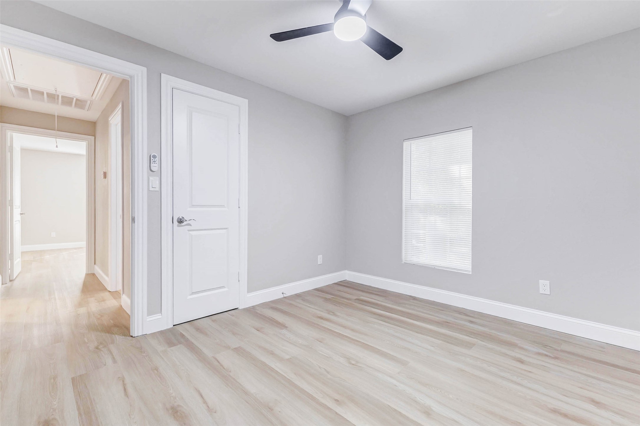 1054 Dewalt Street Houston, TX 77088 - Photo 19 of 24 an empty room with wooden floor cabinet and windows