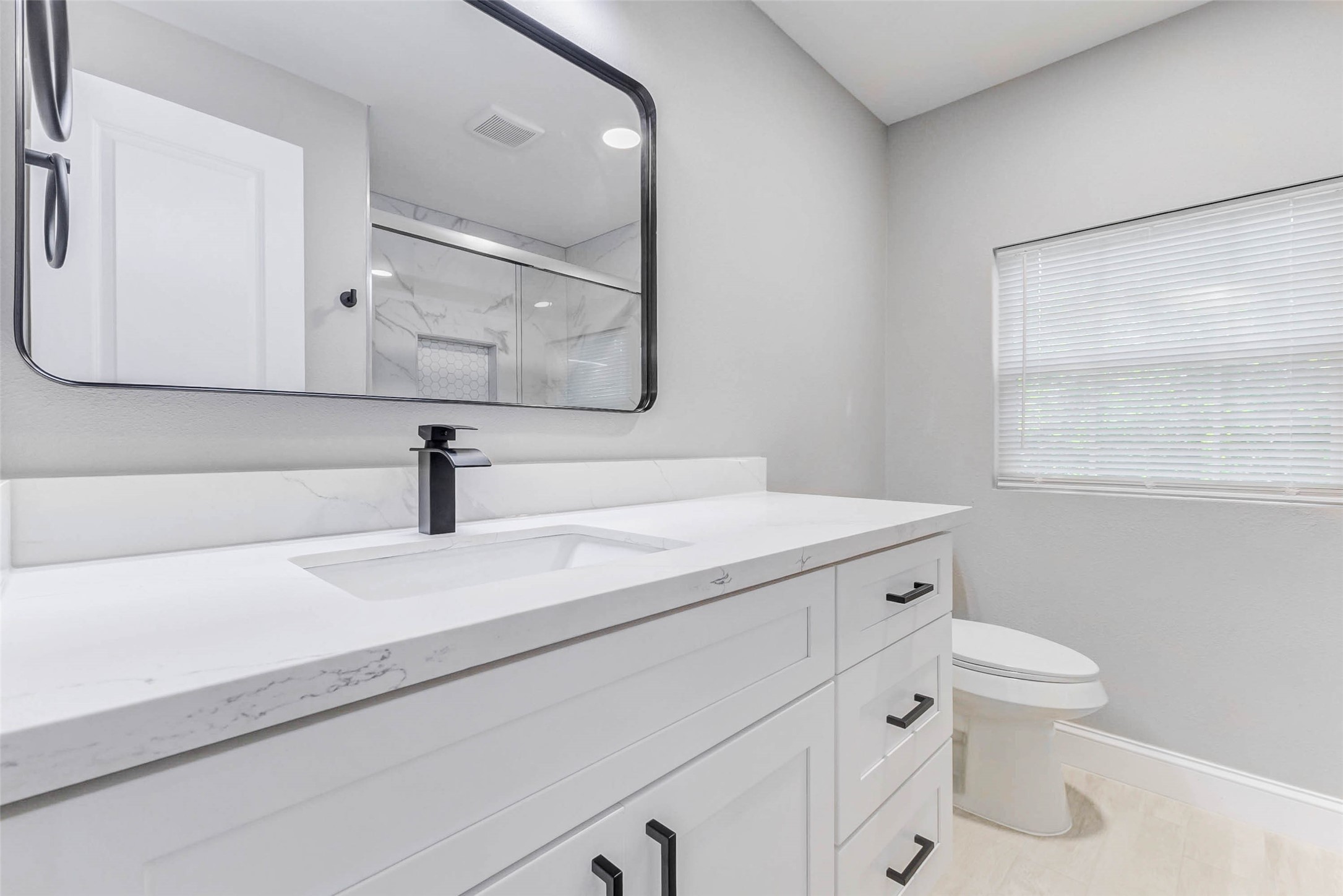 1054 Dewalt Street Houston, TX 77088 - Photo 20 of 24 a bathroom with a sink a toilet and mirror