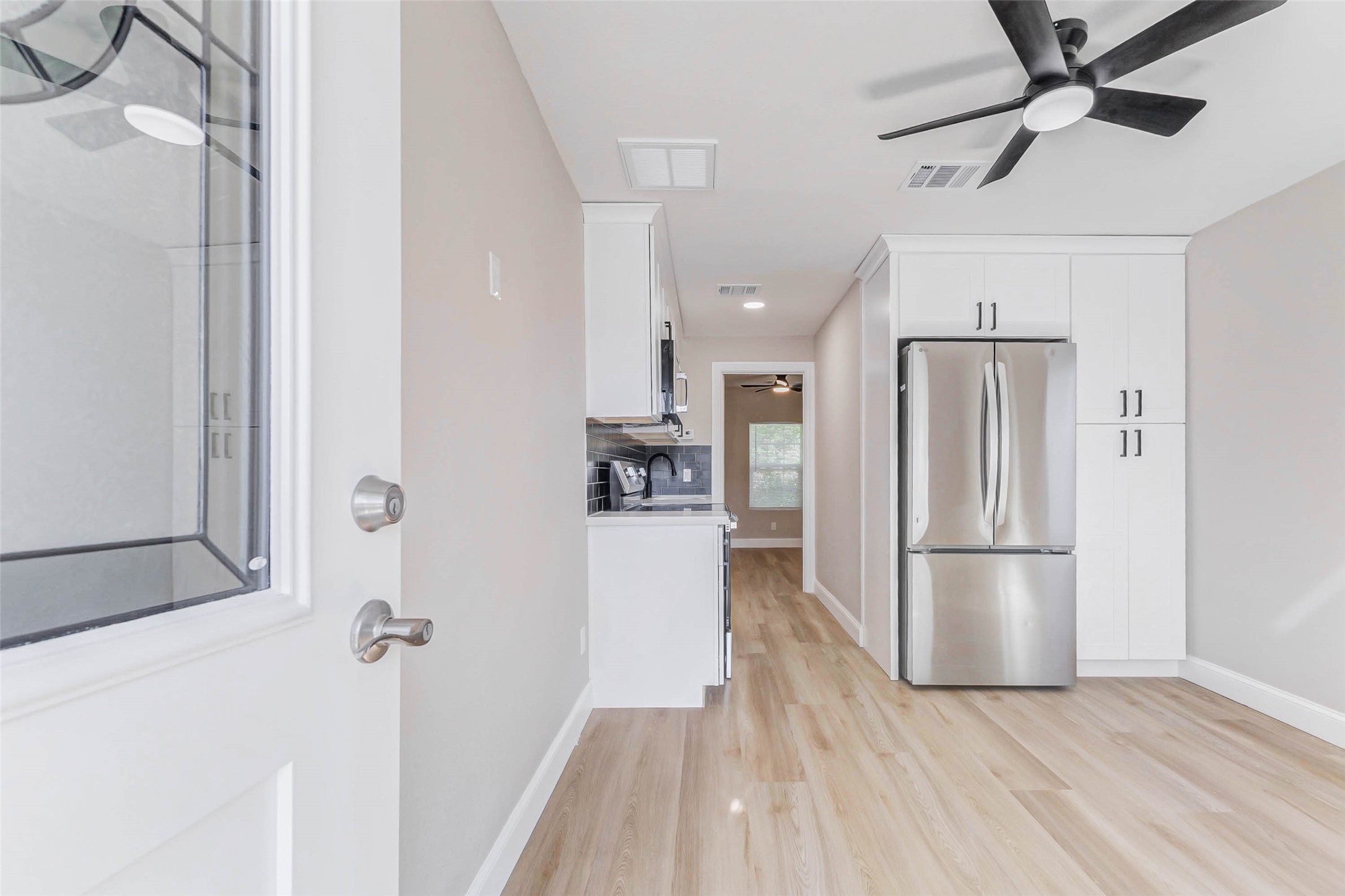 1054 Dewalt Street Houston, TX 77088 - Photo 4 of 24 a kitchen with a refrigerator a sink and a stove top oven