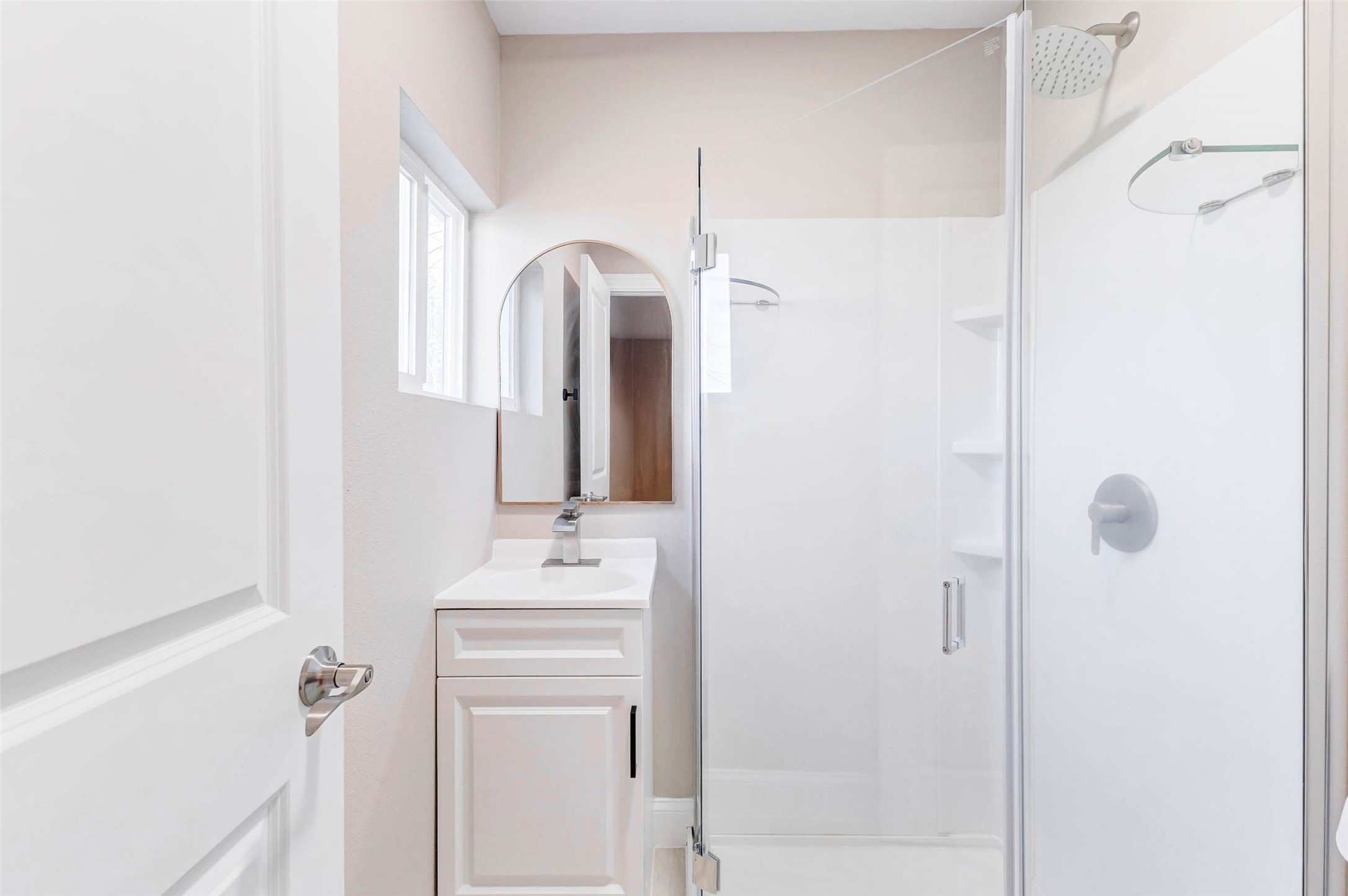 1054 Dewalt Street Houston, TX 77088 - Photo 10 of 24 a bathroom with a sink mirror and shower
