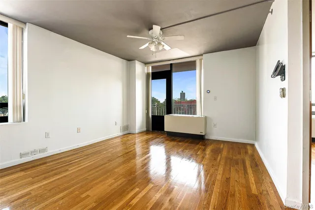 wooden floor in an empty room with a window