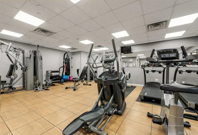 a living room with furniture and a dining table with kitchen view