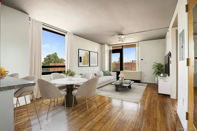 a view of a big room with wooden floor and windows