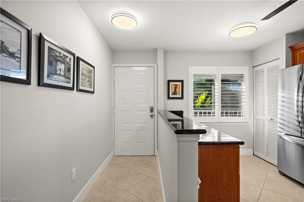 3012 Sandpiper Bay Circle, Unit D302 Naples, FL 34112 - Photo 6 of 16 a view of kitchen with furniture and large window