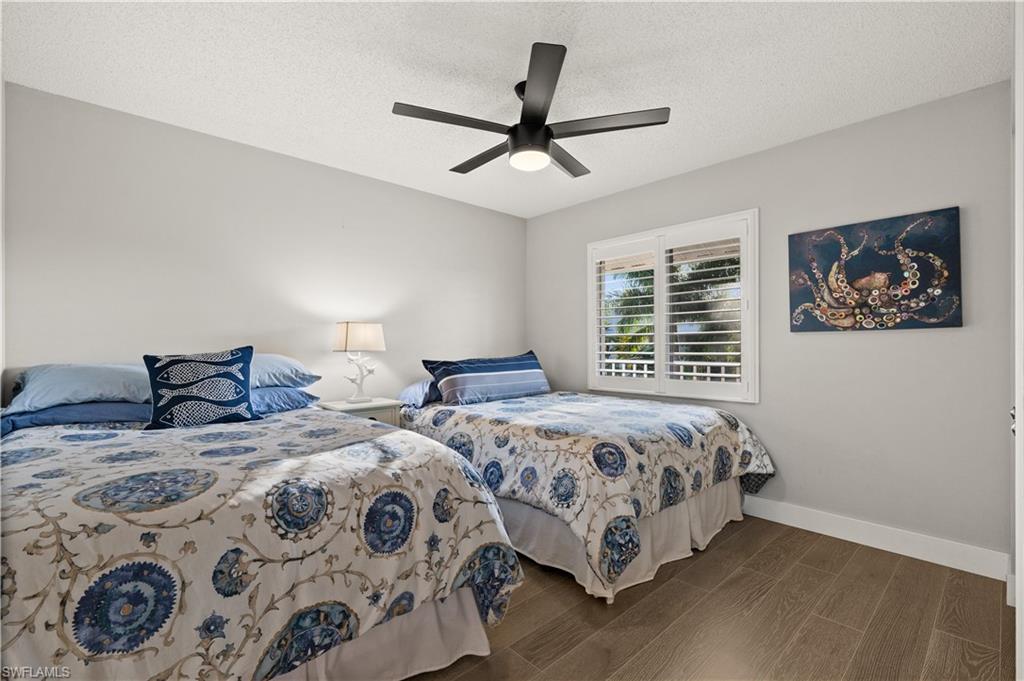 3012 Sandpiper Bay Circle, Unit D302 Naples, FL 34112 - Photo 9 of 16 a bedroom with two beds and a window