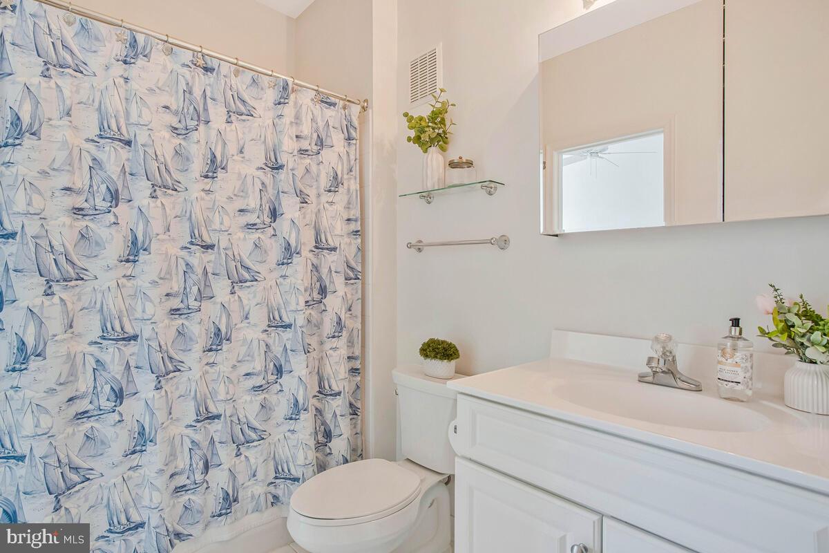 735 Runabout Loop, Unit 735 Solomons, MD 20688 - Photo 28 of 51 a bathroom with a granite countertop sink and a toilet