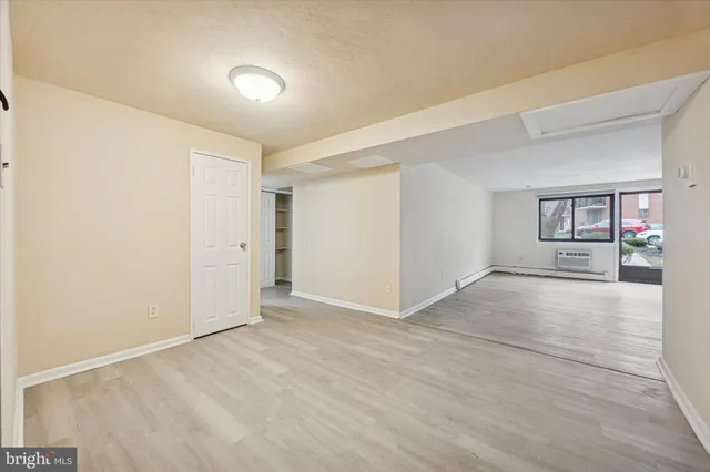 an empty room with windows and entrance