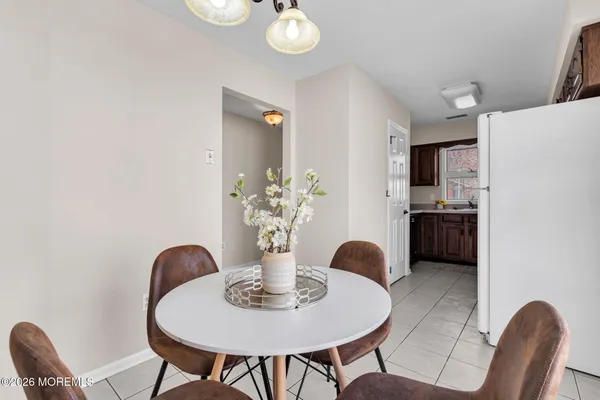 a dining room with furniture and chandelier