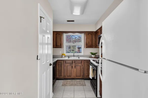 a kitchen with a sink a window and cabinets
