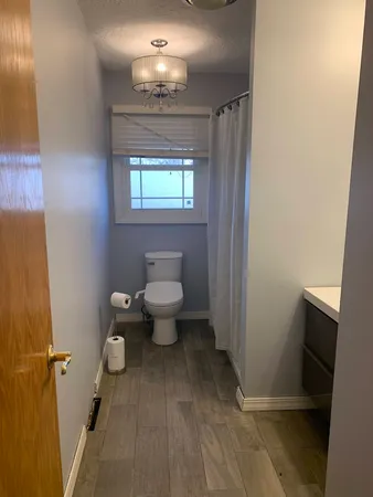 a bathroom with a toilet sink and shower