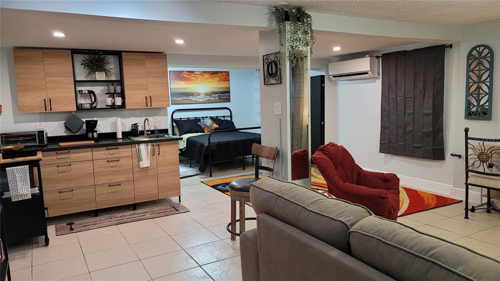 Undisclosed Address Orlando, FL 32803 - Photo 1 of 1 a living room with furniture and a flat screen tv